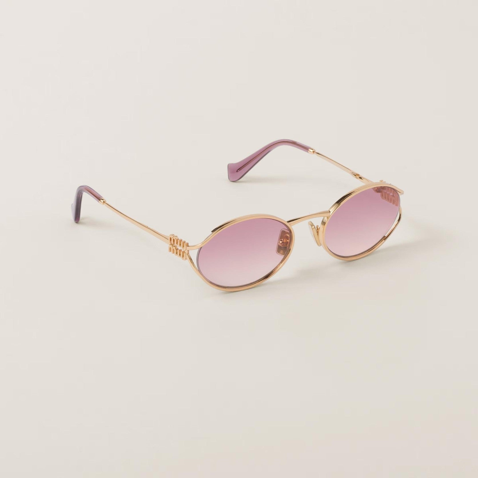 Miu Miu oval metal glasses in rose gold with adjustable nose pads, UV protection.
