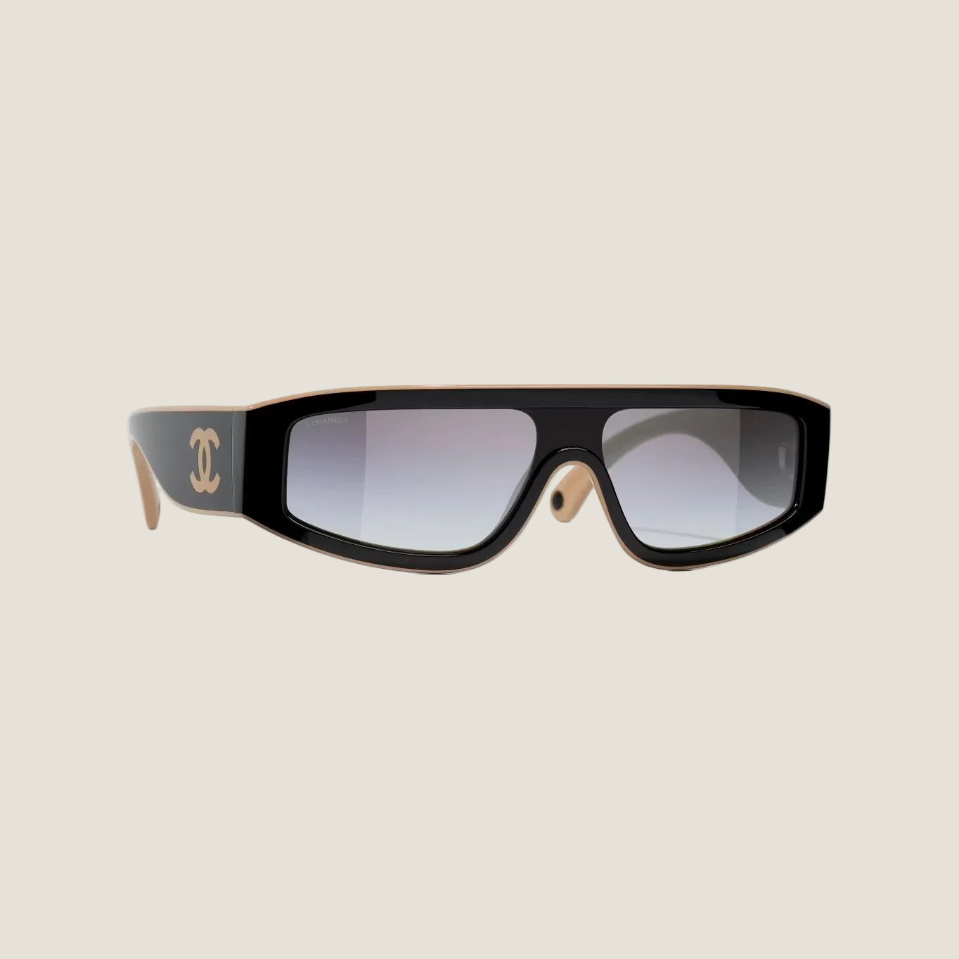 Image of Black and brown CHANEL sunglasses with plastic frame and adjustable nose pads, offering 100% UVA/UVB protection.