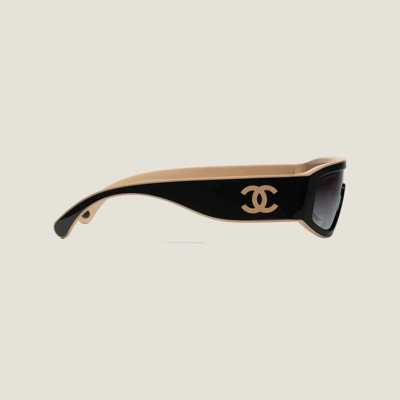 Image of Black and brown CHANEL sunglasses with plastic frame and adjustable nose pads, offering 100% UVA/UVB protection.