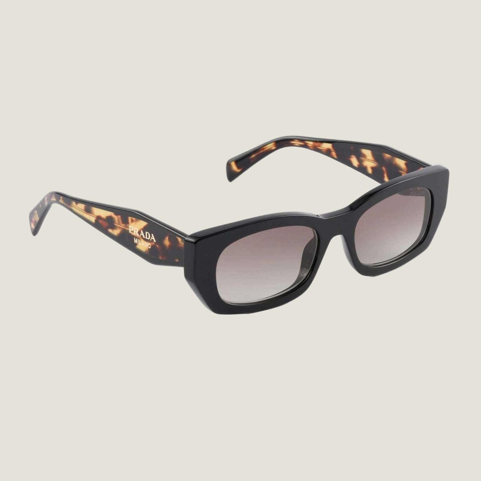 Image of Prada designer sunglasses with bold logo and geometric frames, tortoiseshell pattern.