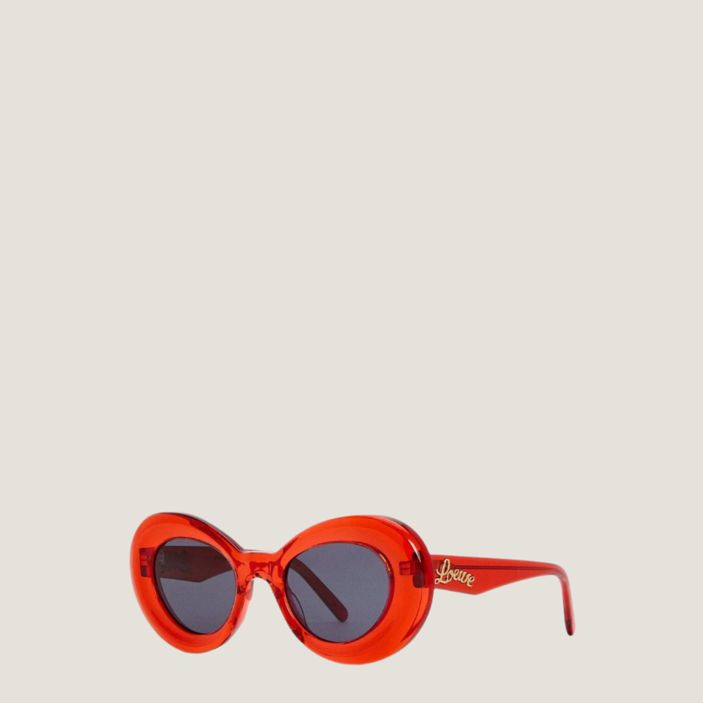 Red LOEWE sunglasses with geometric frames and UV400 protection.