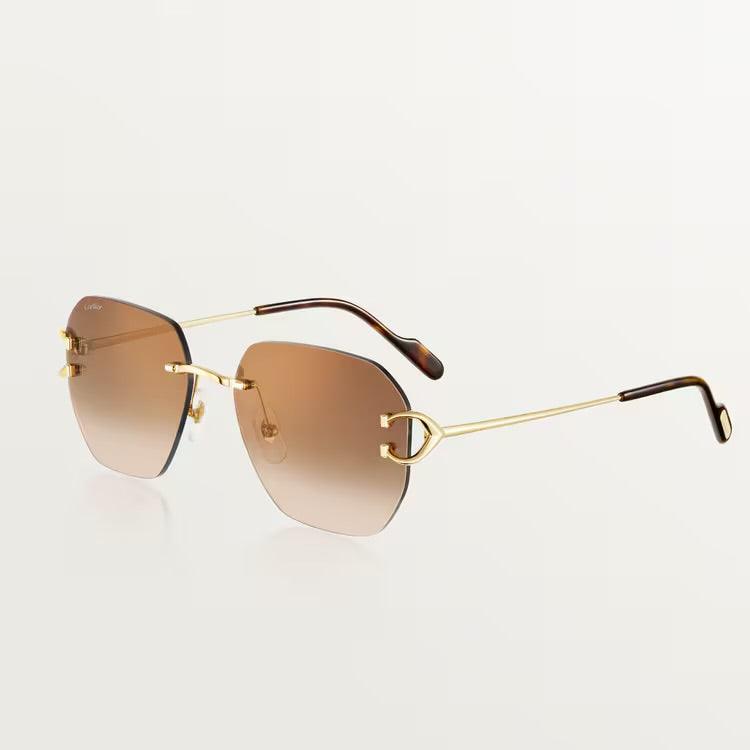 Image of Cartier luxury sunglasses with gold-plated metal frame and UV400 protection lenses.