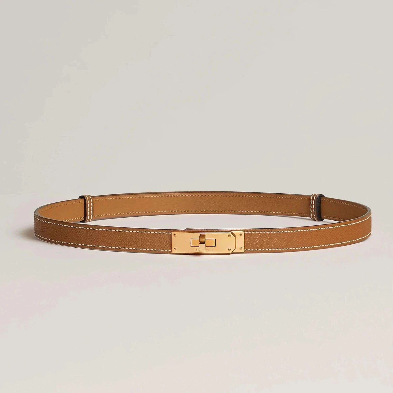Image of Hermes Kelly leather belt with elegant metallic buckle, luxury accessory in brown finish.
