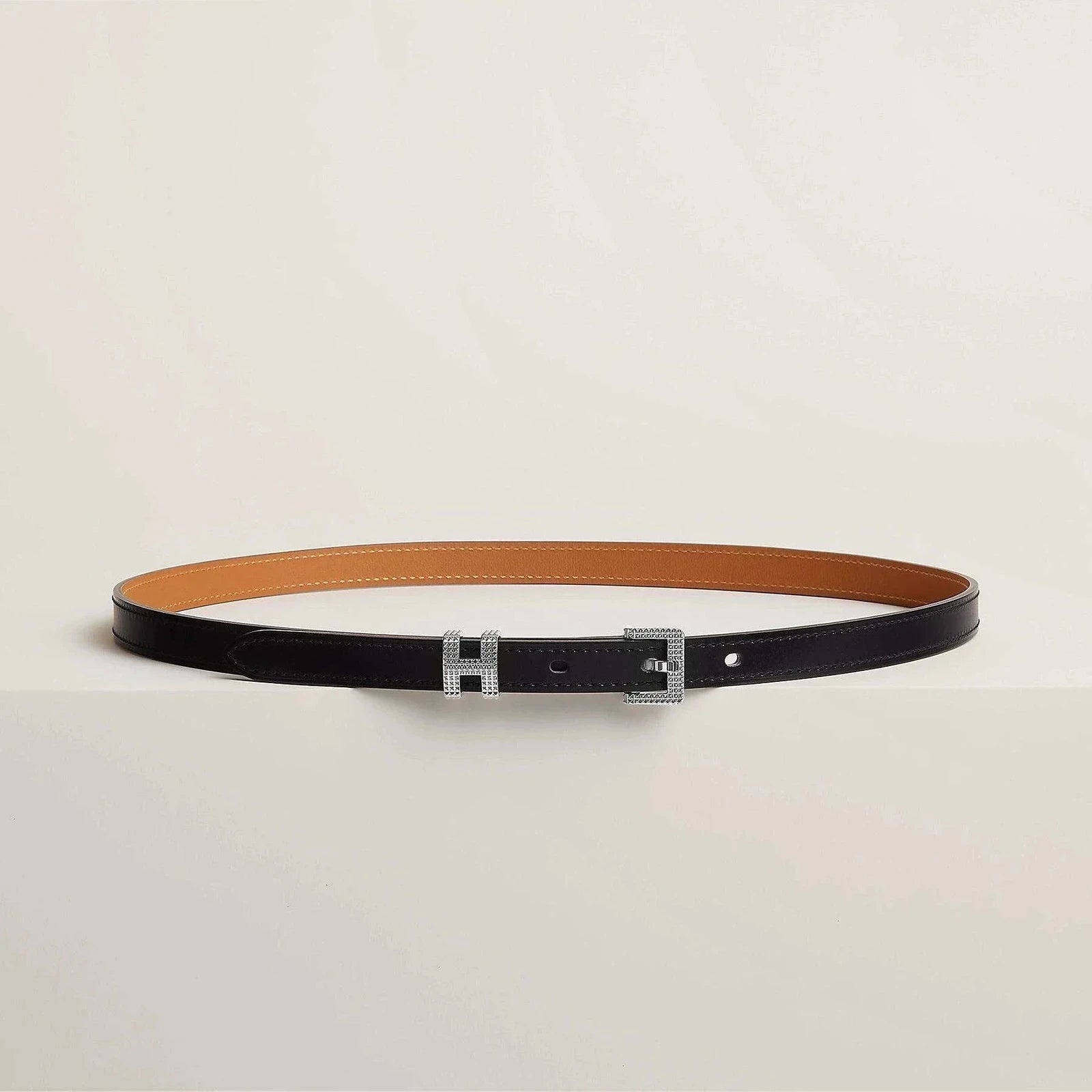 Luxury Hermes belt in premium leather with sleek metallic buckle, minimalistic and elegant design for sophisticated style.