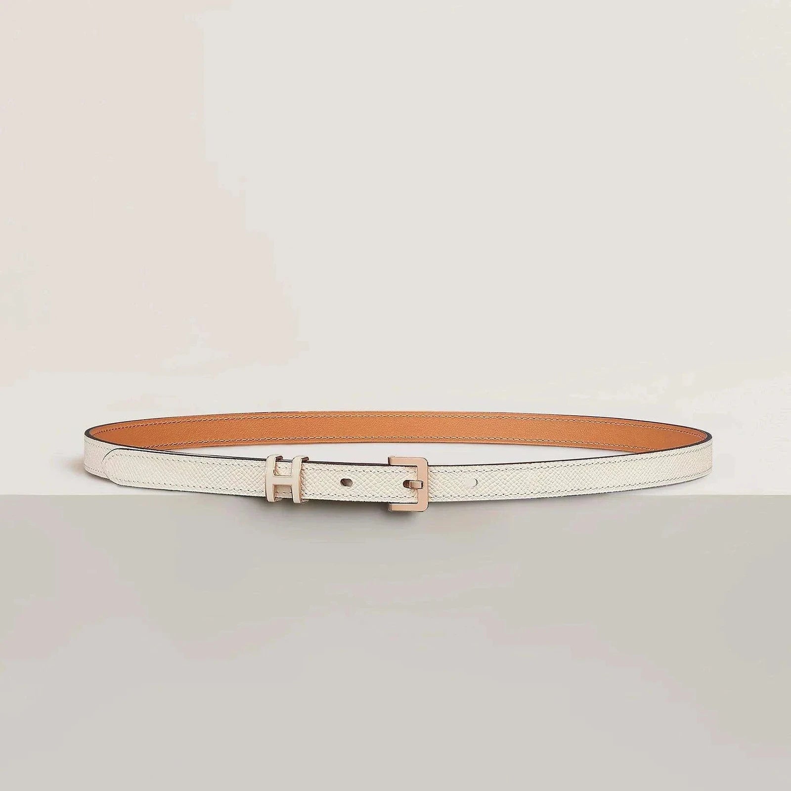 Luxury Hermes leather belt with minimalist design and elegant metallic buckle, showcasing premium craftsmanship.