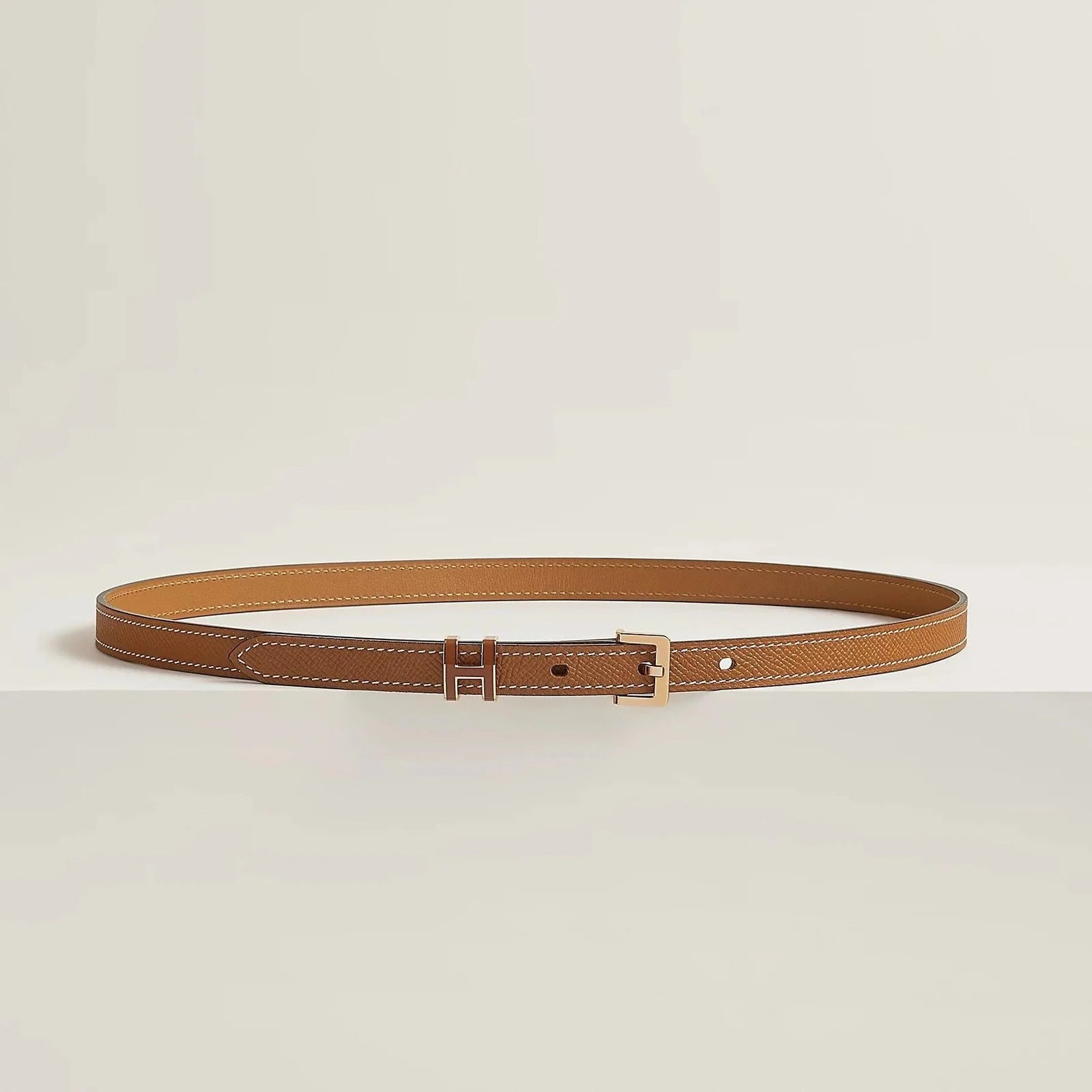 Premium leather Hermes belt with elegant metallic buckle, showcasing minimalist design and luxury craftsmanship.