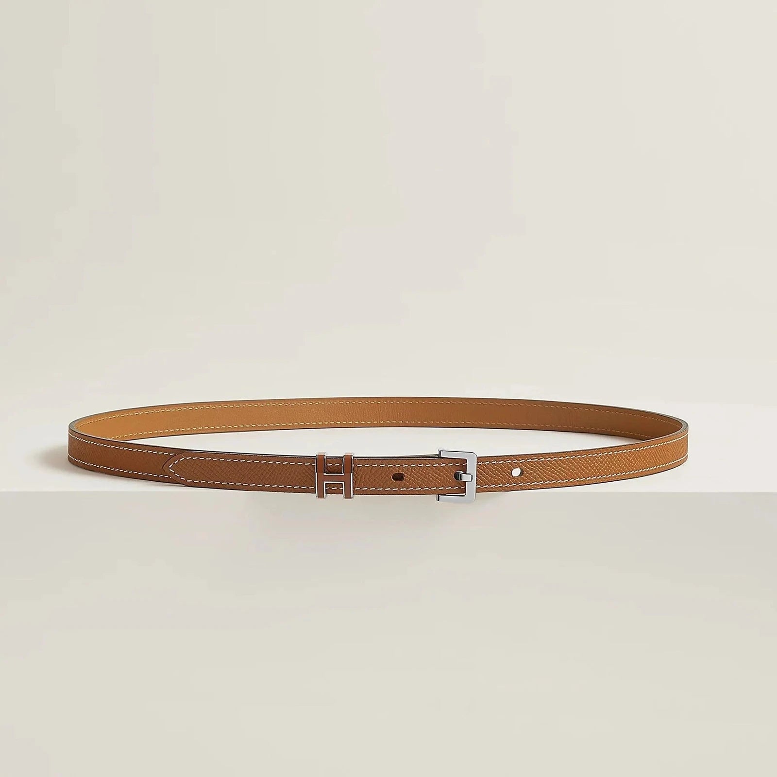 Image of Luxurious Hermès leather belt with elegant metallic buckle, minimalist design, premium quality.