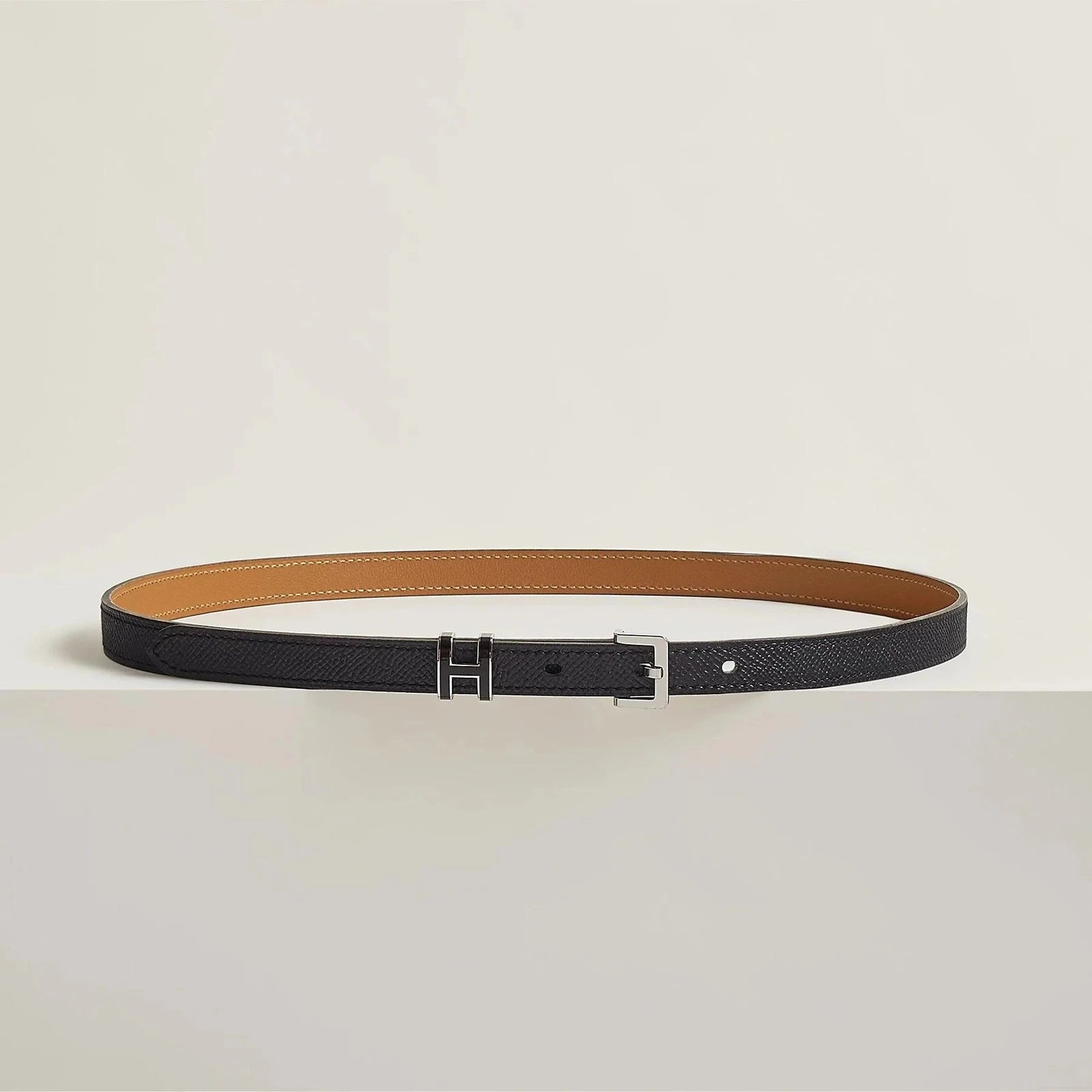 Image of Premium Hermes leather belt with sleek metallic buckle, minimalist luxury accessory.