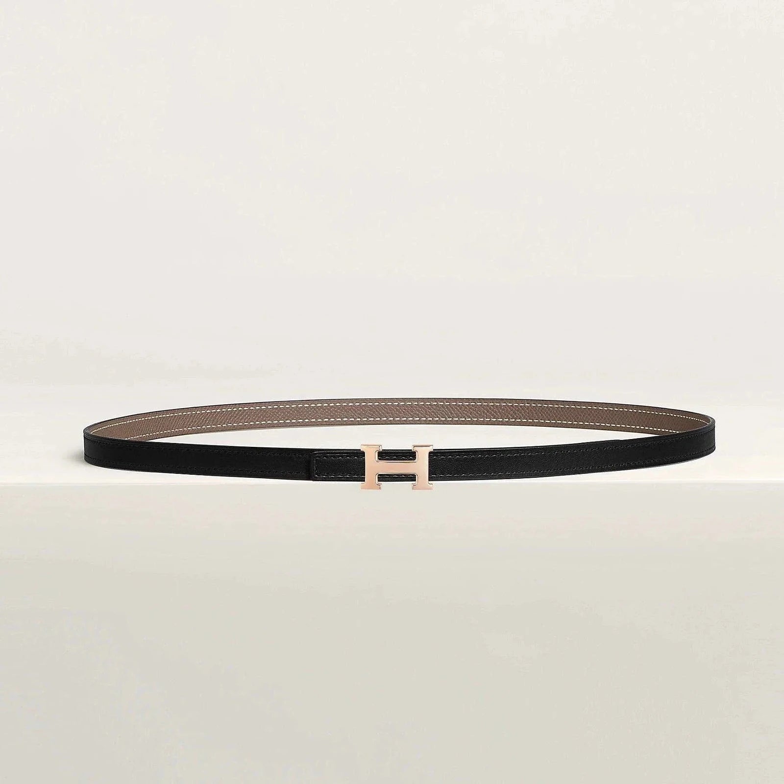 Luxury Hermes reversible belt with elegant metallic buckle and premium leather finish.