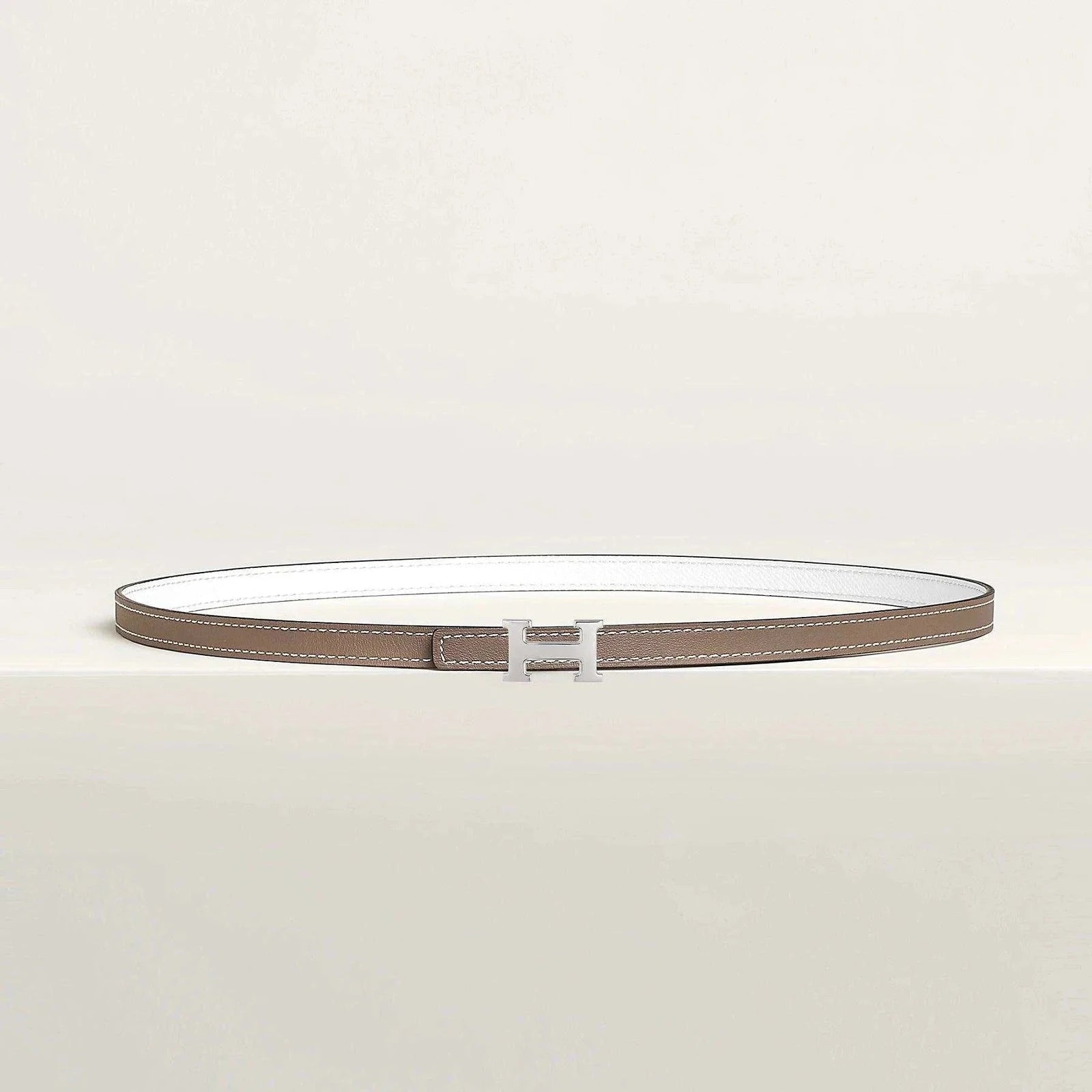 Premium Hermes belt with minimalist design and elegant metallic buckle.
