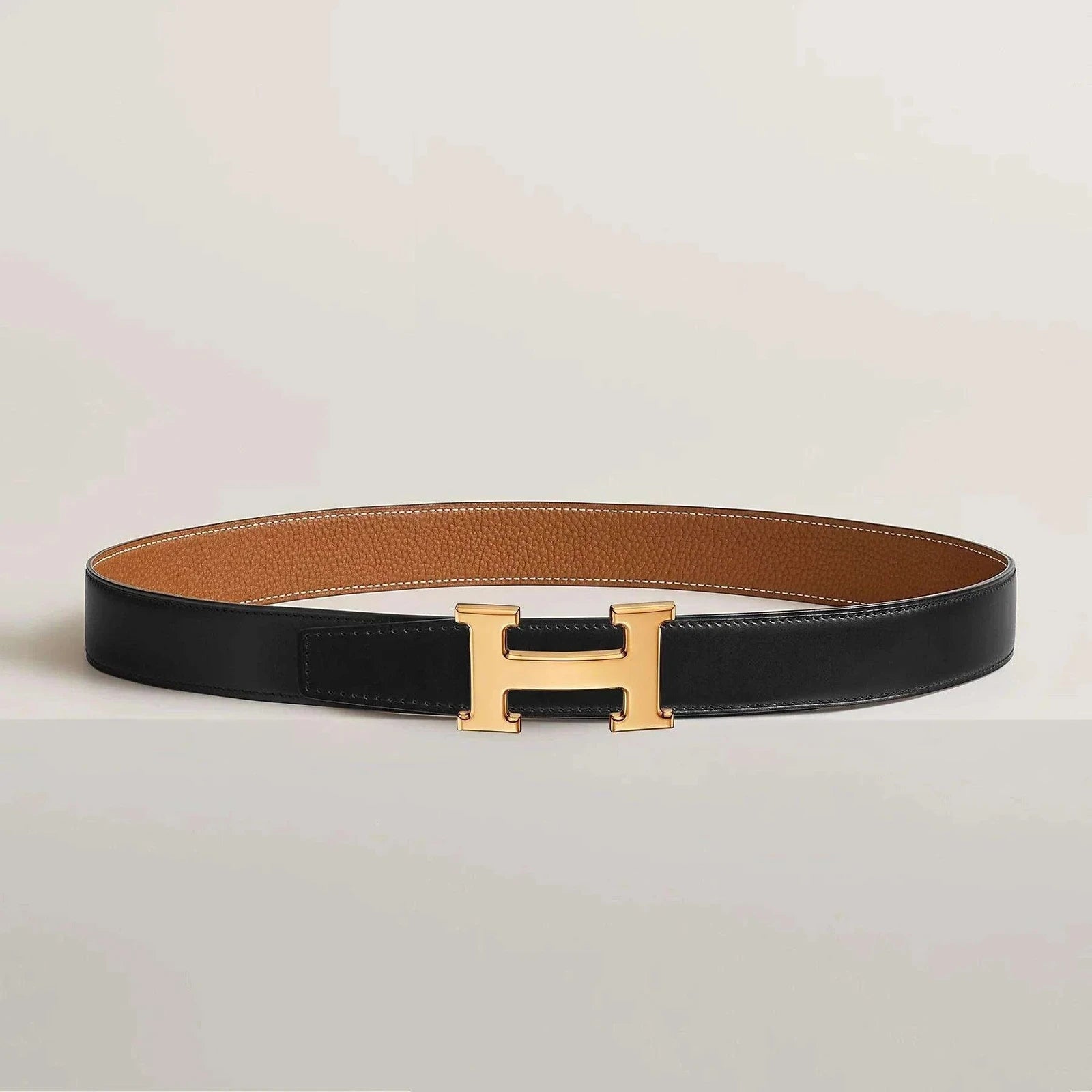 Thick reversible leather belt with gold buckle.