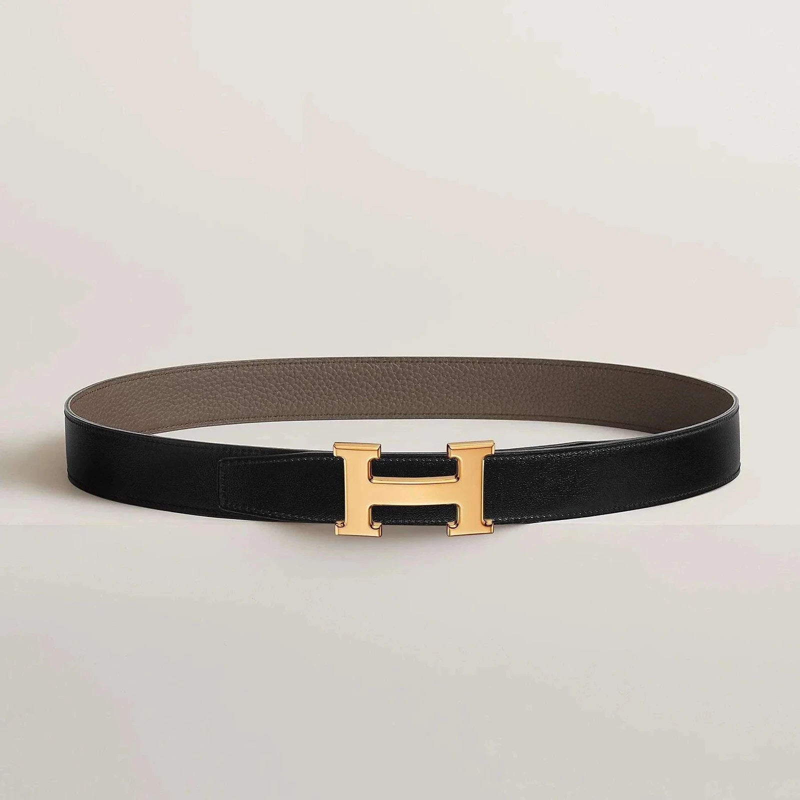 Image of Luxurious Hermès leather belt with gold buckle, reversible design.