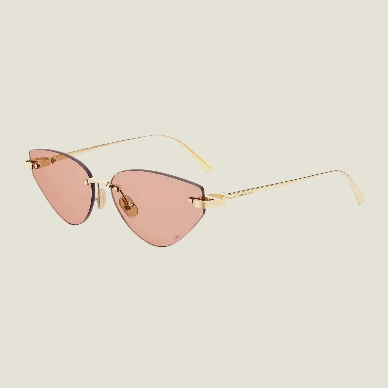 Image of Dior sunglasses with bold geometric frames and pink lenses, featuring UV400 protection.