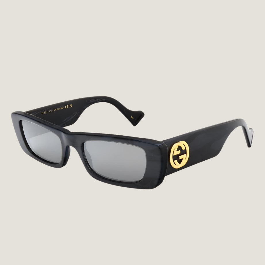 Image of Gucci iconic luxury sunglasses with UV400 protection, stylish black frame, and gold logo.