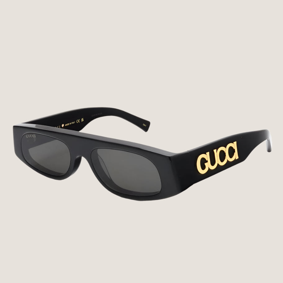 Image of Gucci sunglasses with iconic luxury design, featuring bold black frames and gold logo detailing.