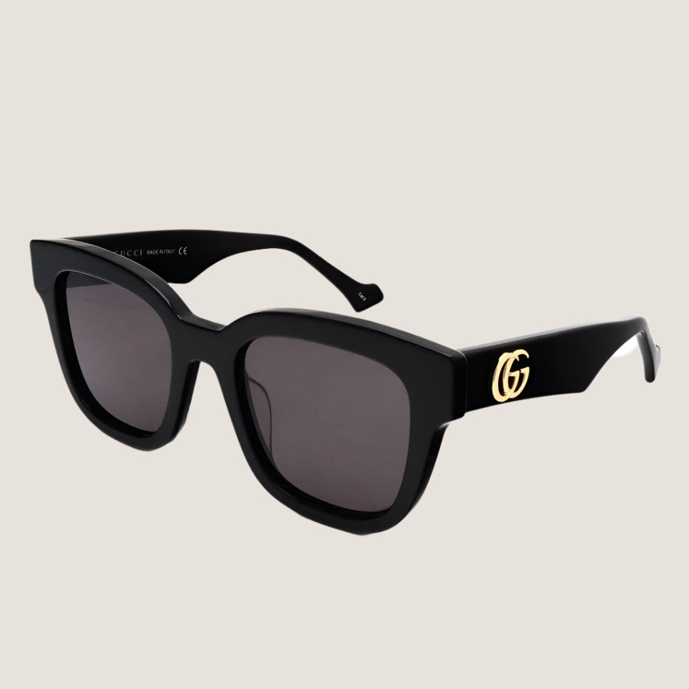 Image of Gucci sunglasses with black frames and GG logo, luxury eyewear.