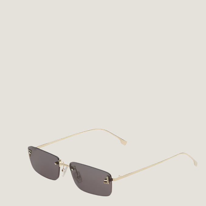 Fendi sunglasses with gold frames and dark lenses, iconic Italian design.