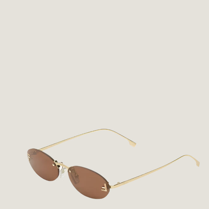 Image of Fendi sunglasses with gold frames and brown lenses, embodying Roman luxury.