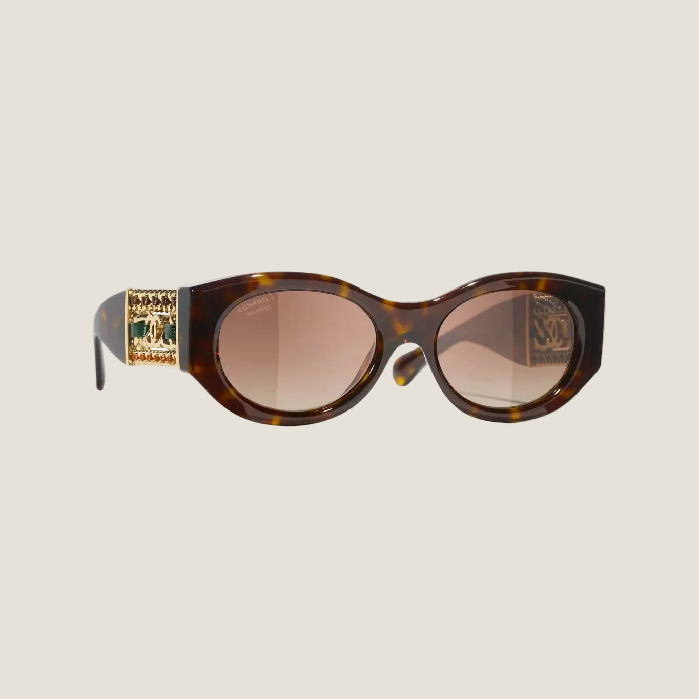 Image of CHANEL sunglasses with tortoiseshell pattern, plastic frame, 100% UVA/UVB protection.
