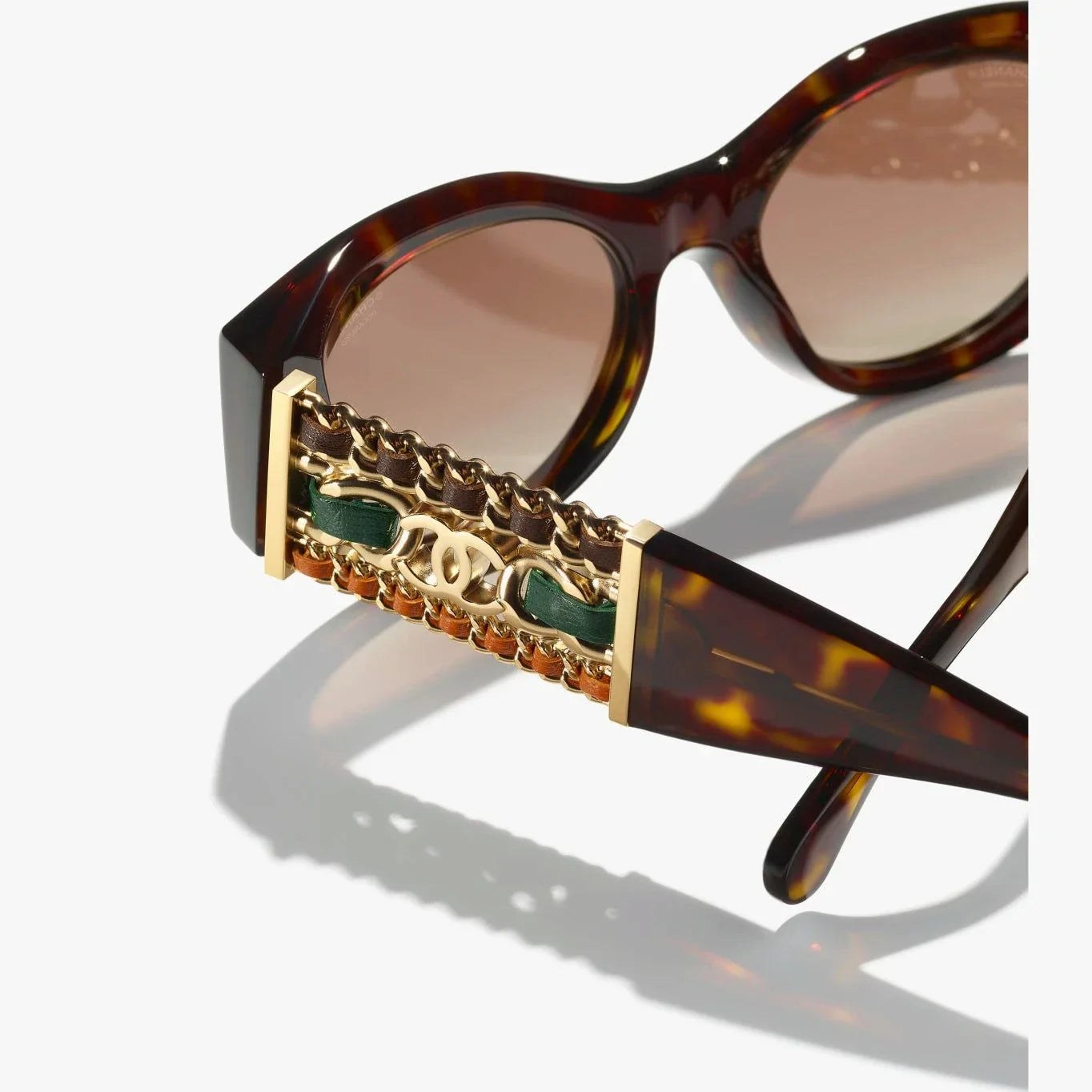Image of CHANEL sunglasses with tortoiseshell pattern, plastic frame, 100% UVA/UVB protection.