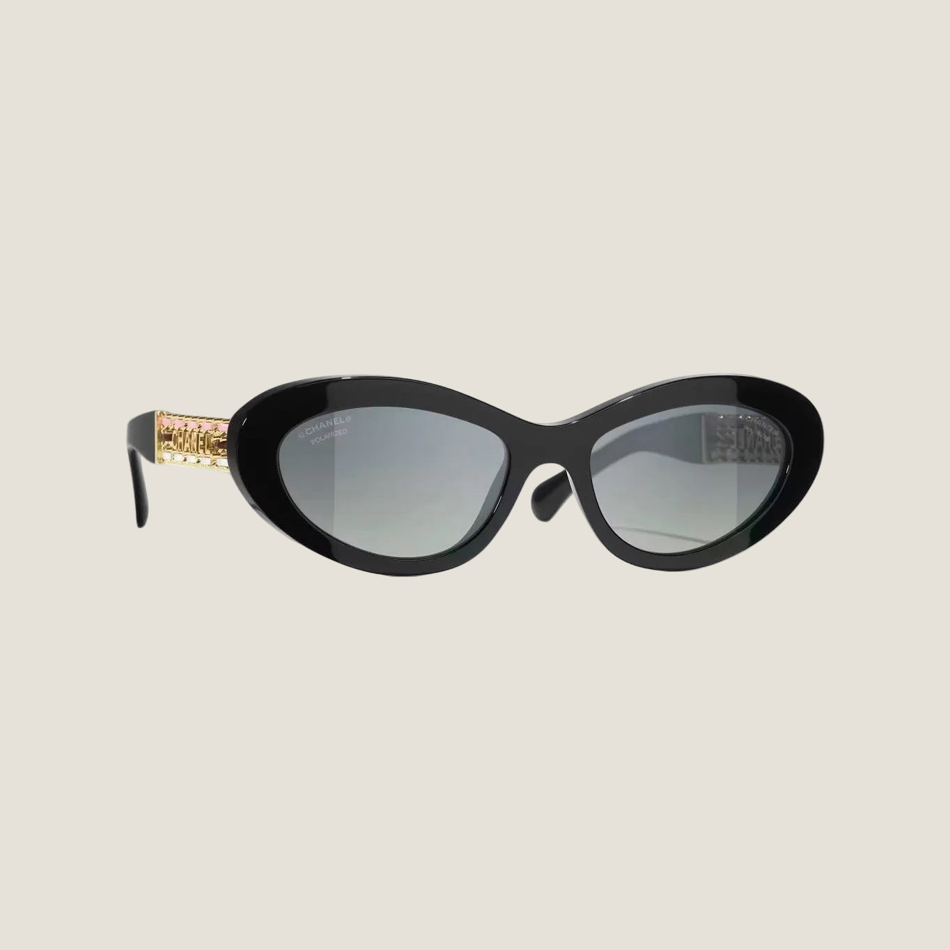 CHANEL sunglasses with black and gold plastic frame, UVA/UVB protection.