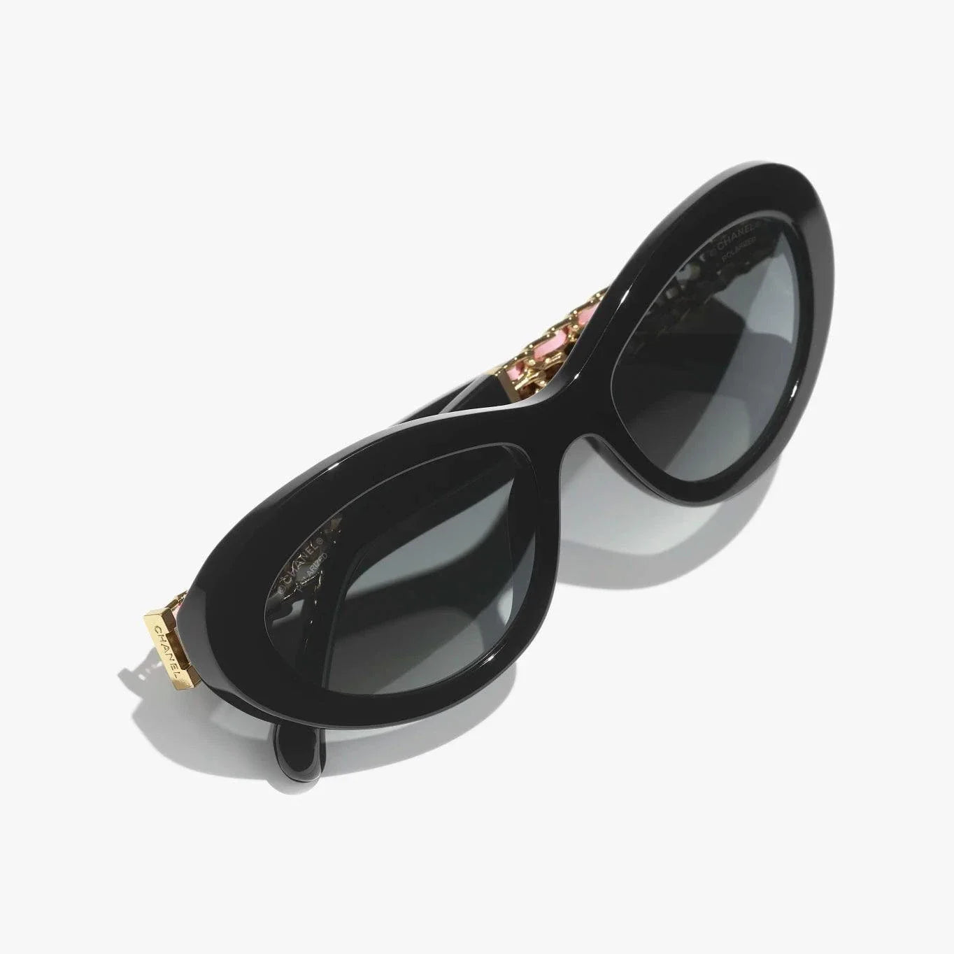 CHANEL sunglasses with black and gold plastic frame, UVA/UVB protection.