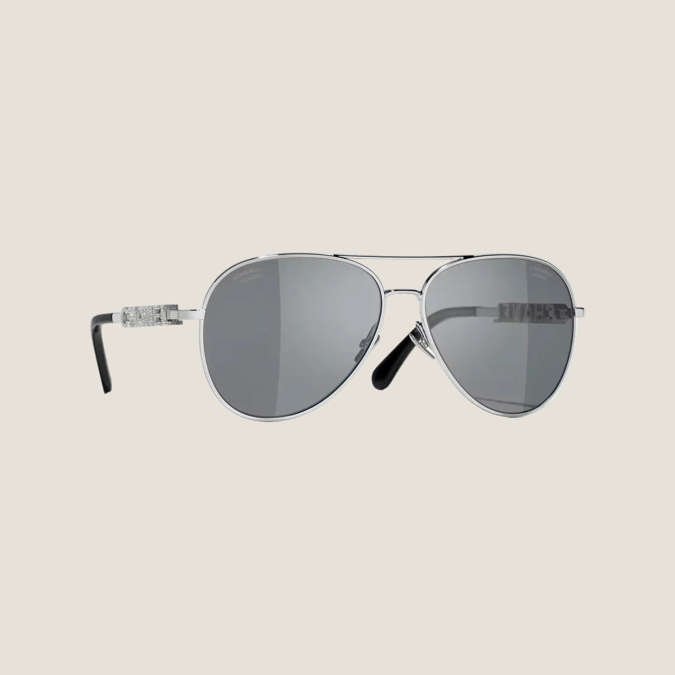 Image of Silver CHANEL sunglasses with plastic frame, UVA/UVB protection, adjustable nose pads.