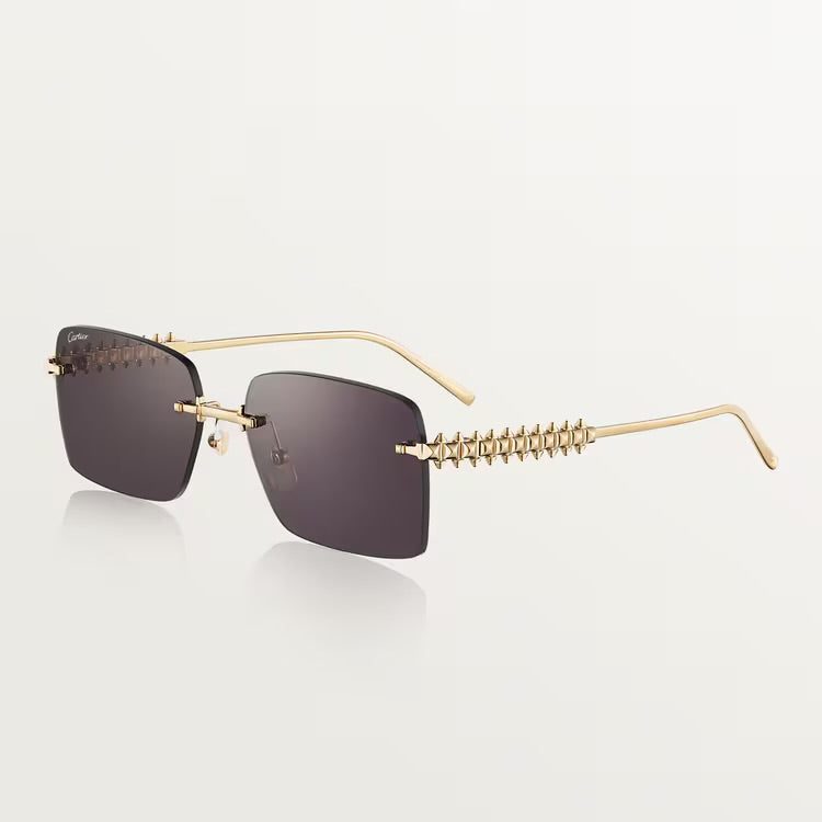 Image of Cartier luxury sunglasses with gold-plated metal frame and UV400 lenses.