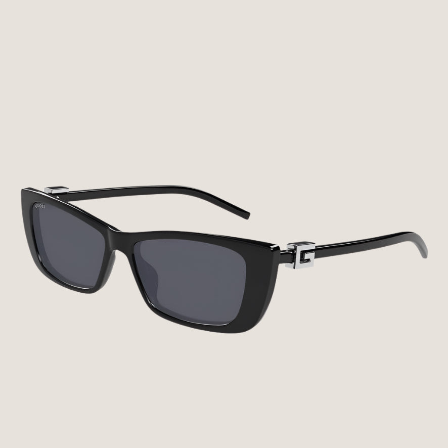 Image of Iconic Gucci sunglasses with sleek black frames and UV400 lenses, combining luxury and modern style.