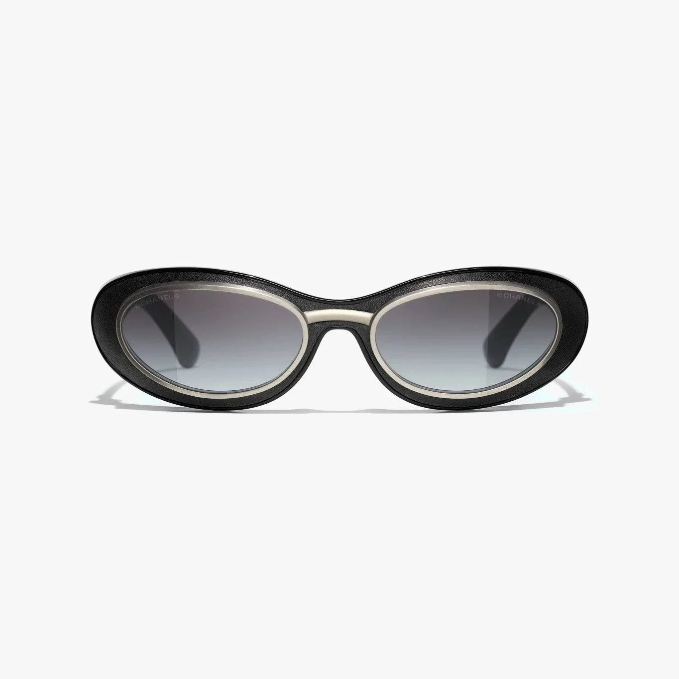 Image of CHANEL sunglasses, black and silver, plastic and metal frame, UVA/UVB protection, adjustable nose pads.