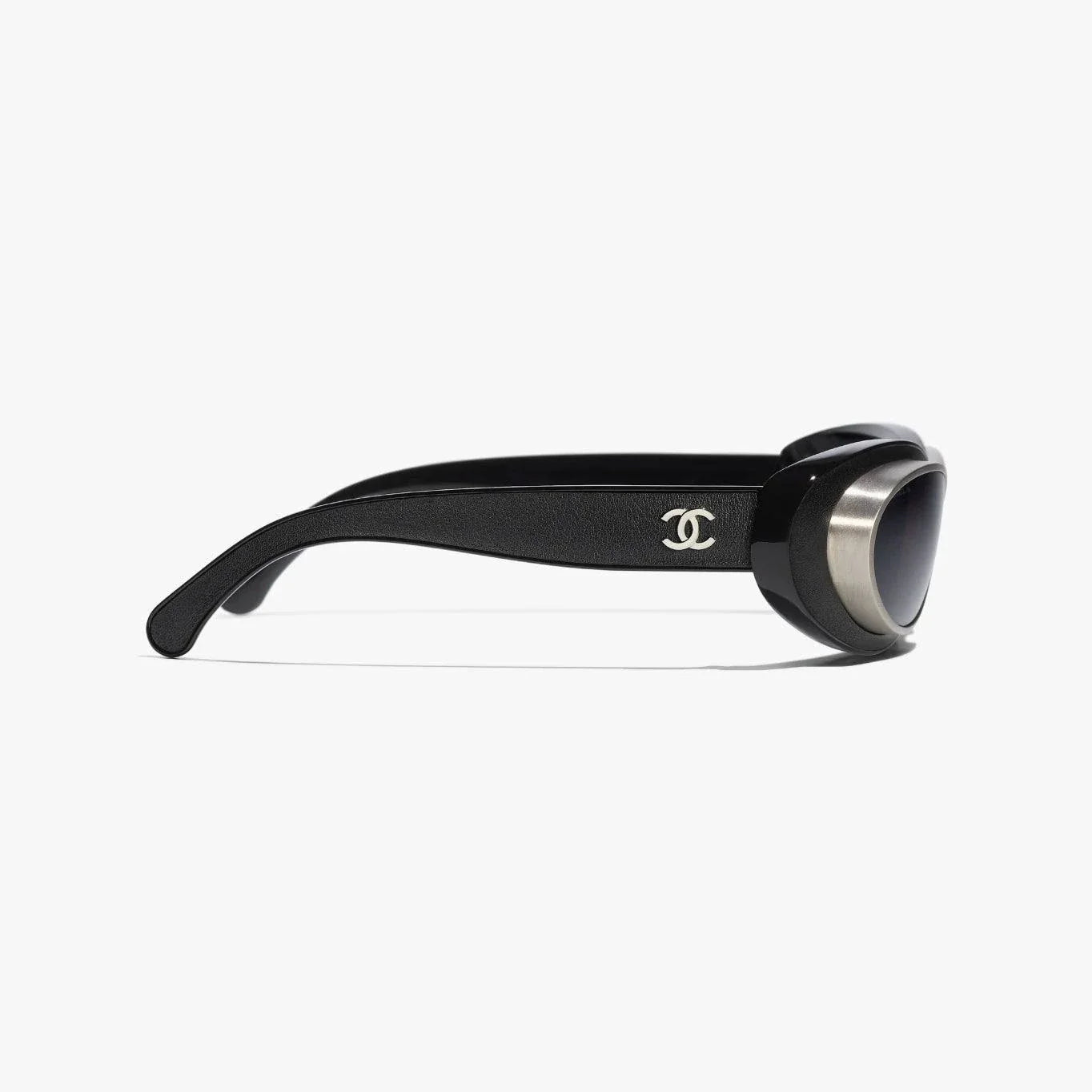 Image of CHANEL sunglasses, black and silver, plastic and metal frame, UVA/UVB protection, adjustable nose pads.